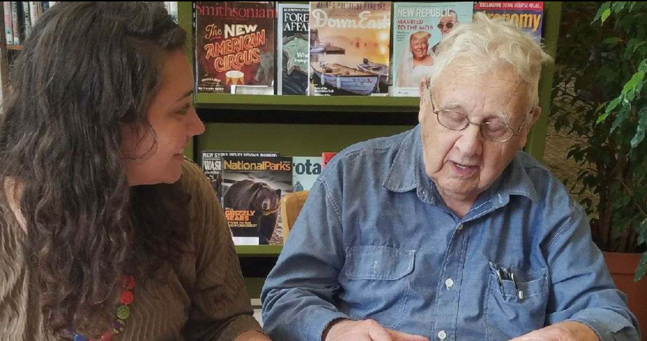 Anna instructing Dick Rice on how to use his new tablet.