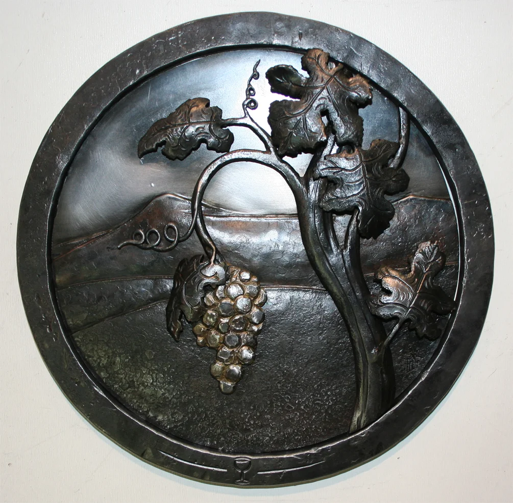  Here Jeremyah combines several metals to 'paint' a scene. This forged 'painting' is then given special patinas to enhance the effect of the image. This is the same technique used for the locomotive medallion. 