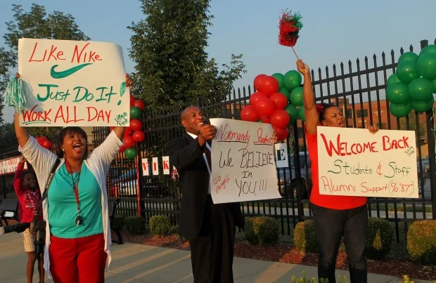 Community members gathered outside Normandy High School, an unaccredited and failing school in St. Louis, MO, to cheer on students beginning the 2014-2015 school year. source: STL Today