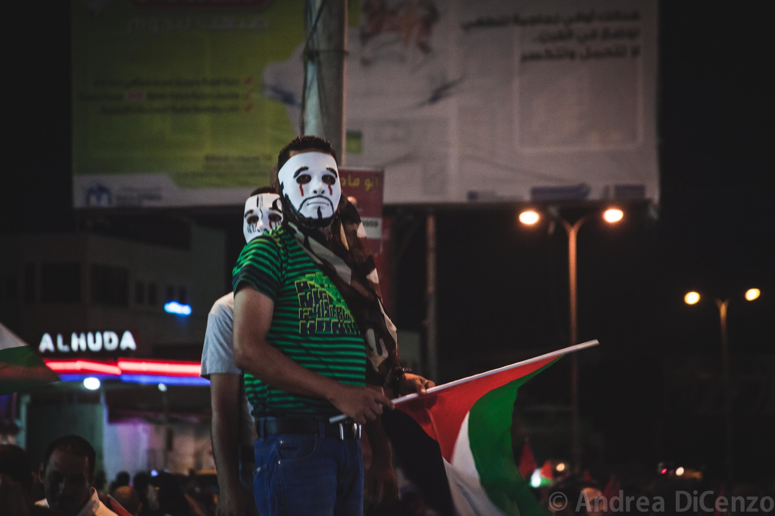  Two protestors survey the crowd in the growingly popular ‘V for Vendetta’ mask. Concealing your identity can be crucial at these sort of demonstrations for&nbsp;Palestinians participating in protests&nbsp;fear that the Israeli military will use phot