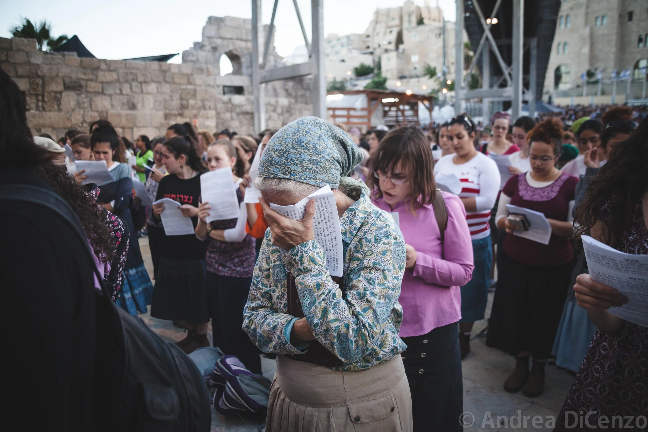 A Jewish woman puts her head in her hand in distress at a prayer vigil that is held for the missing teenage Israeli boys. The teenagers had been missing for four nights.