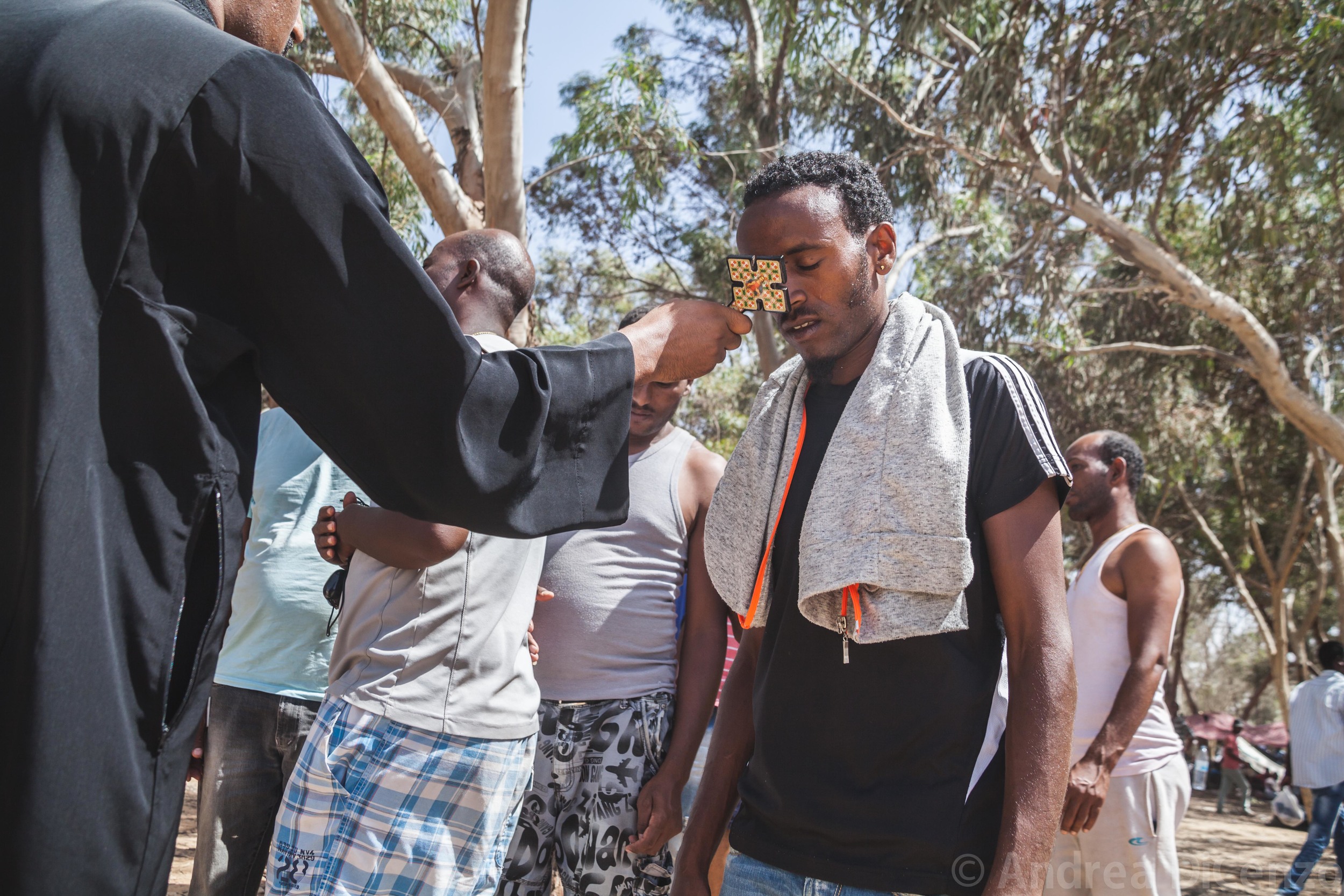  An Eritrean christian receives a blessing from a leader of the Christian community. The gentlemen is part of a protest from asylum seekers in Holot Detention Center who have left the establishment to protest living conditions for them in Israel. 