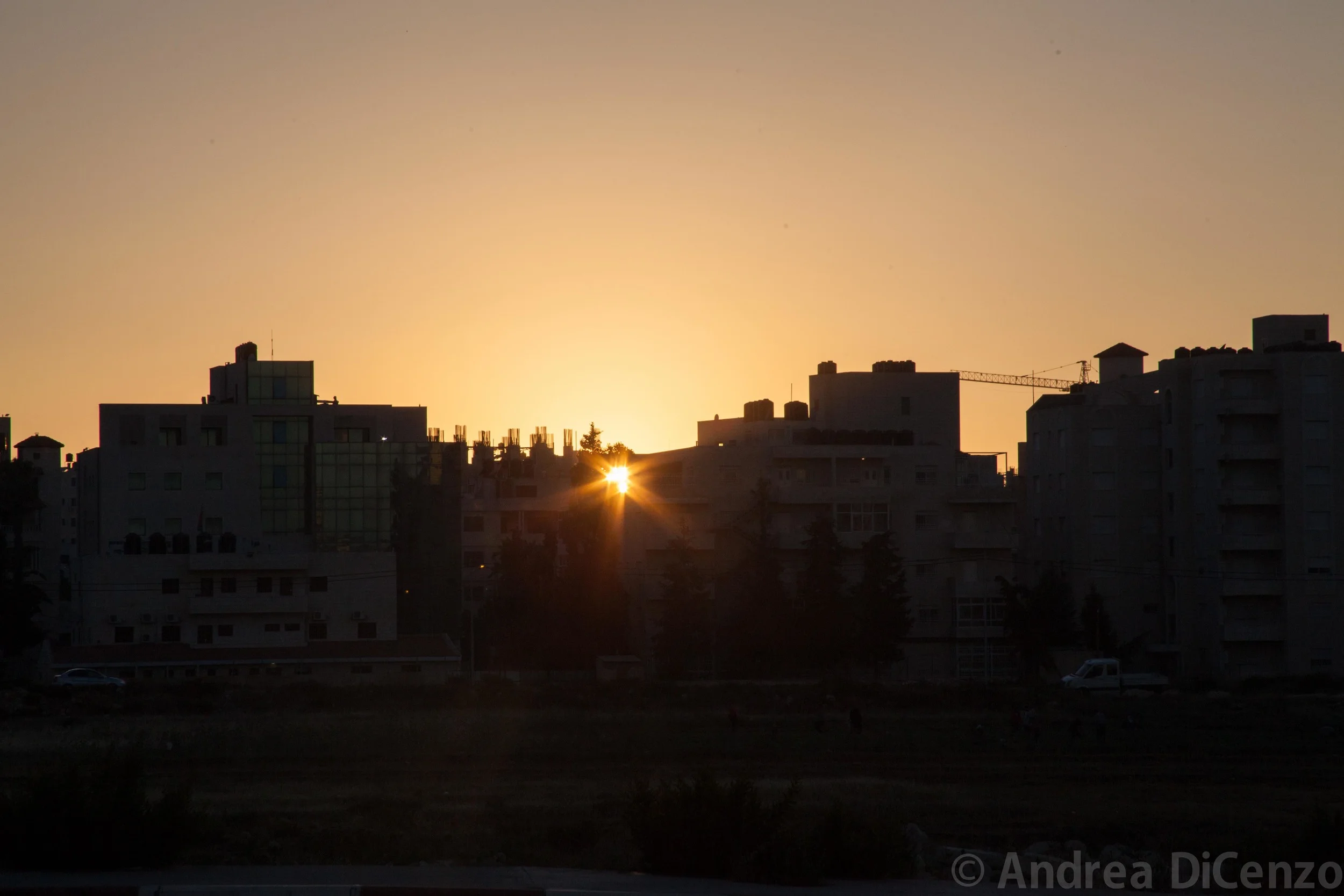 The sun sets in a peaceful Ramallah as the war in Gaza rages on just miles away. 