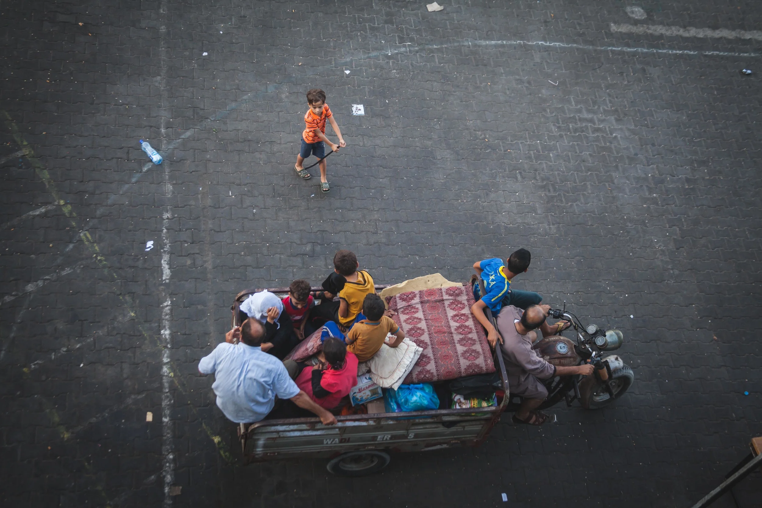 A family loads onto a motor cart as they begin to leave Fakhoora UN school where they have been sheltering from the heavy bombardment as the war raged throughout Gaza and Israel. Gaza City.