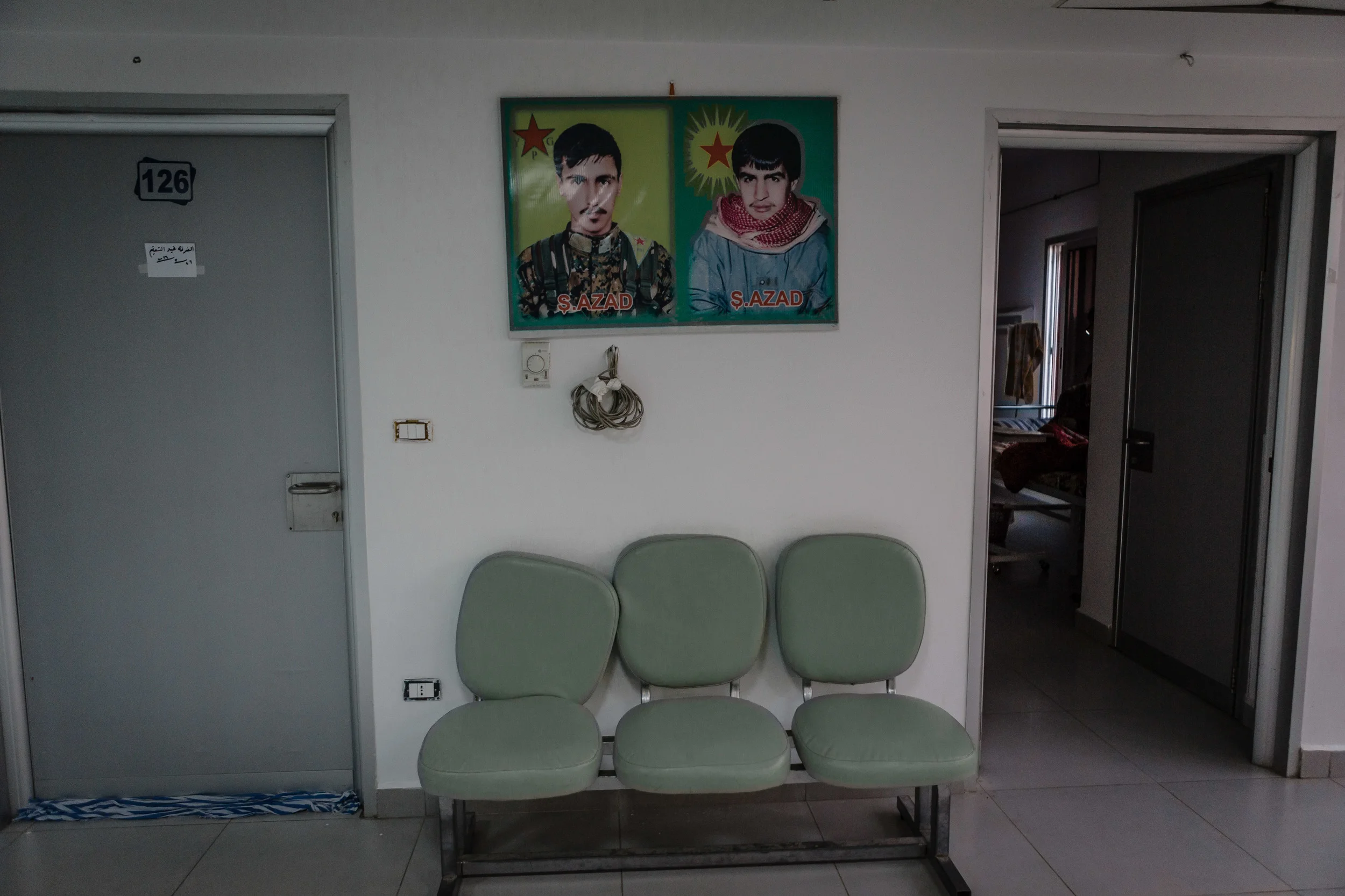 Portraits of martyred YPG fighters hang inside the halls of Xebat Hospital.