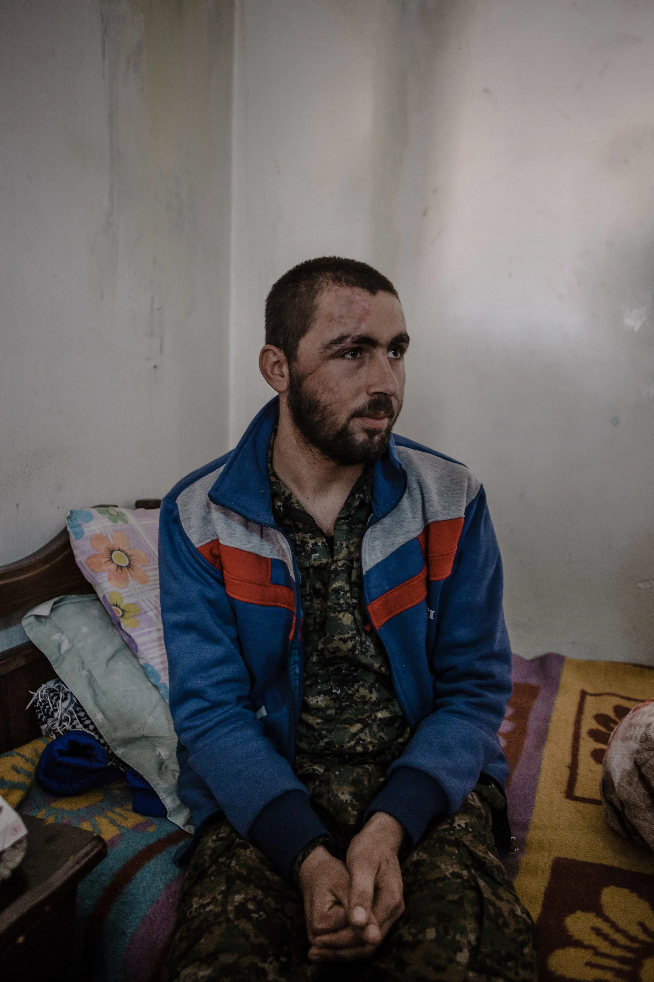 An injured YPG fighter in an outpatient medical facility in northern Syria.