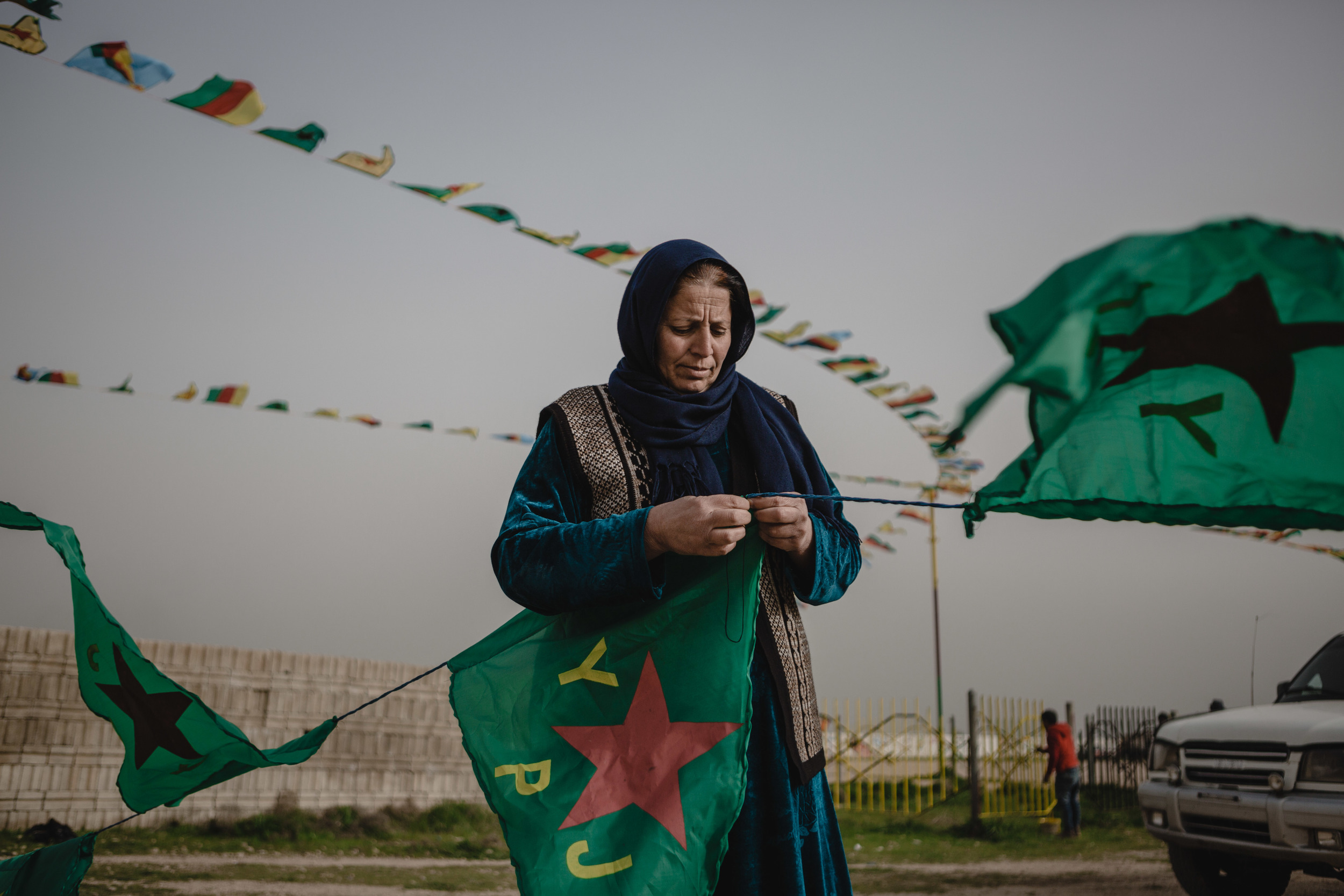  A women sews Kurdish People's Defence Units (YPG) flags in Amude, Syria. The flags are for Newroz celebration that are being organized by the Democratic Union Party (PYD). 
