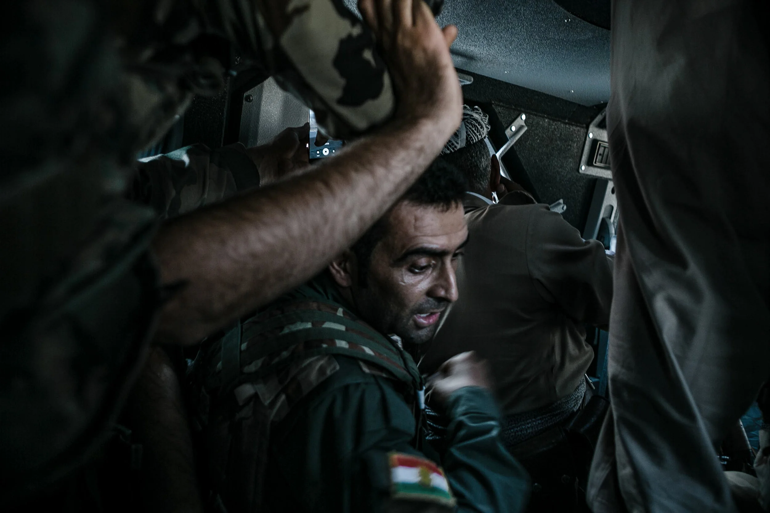 A Peshmerga fighter reaches to reload new rounds of ammunition during a moment of heavy incoming fire from jihadists of the Islamic State.