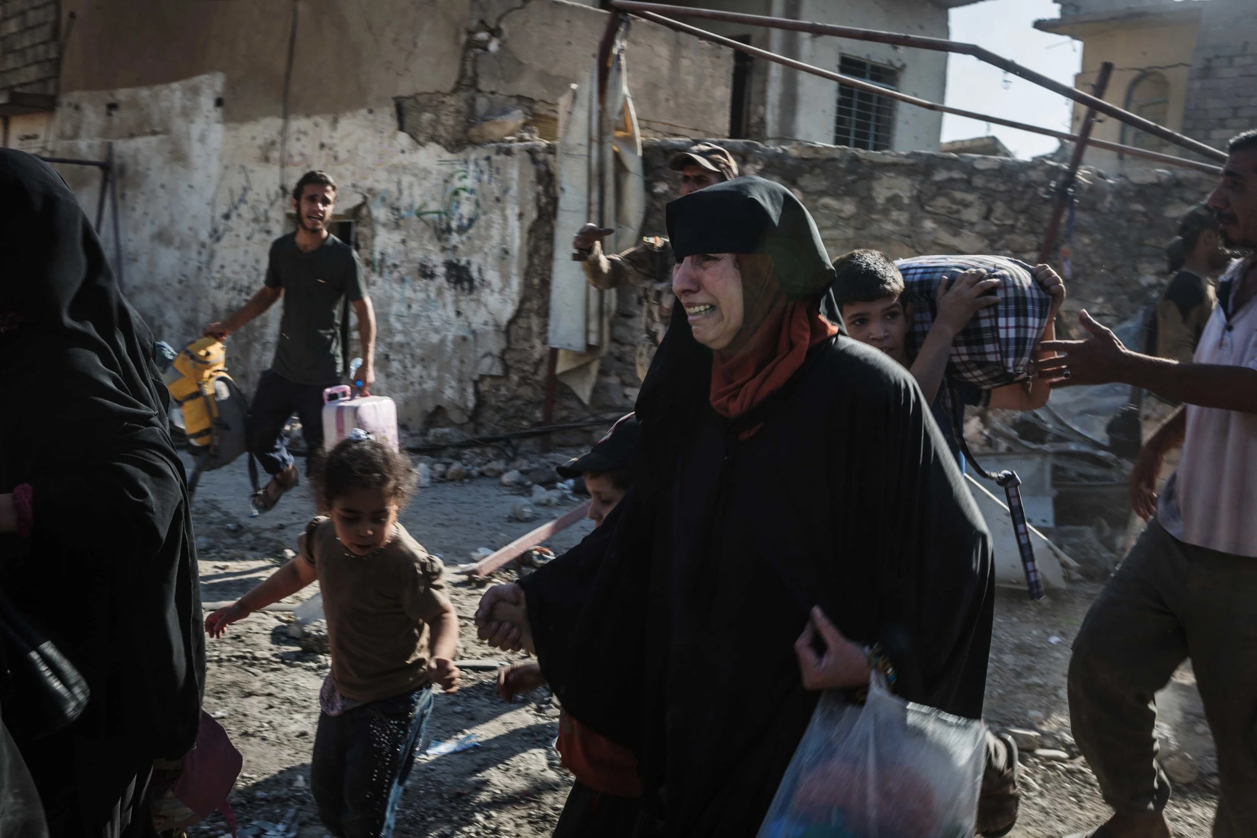 Civilians flee al-Zinjili neighborhood in west Mosul, one of the last remaining neighborhoods under Islamic State control during the nine-month battle.