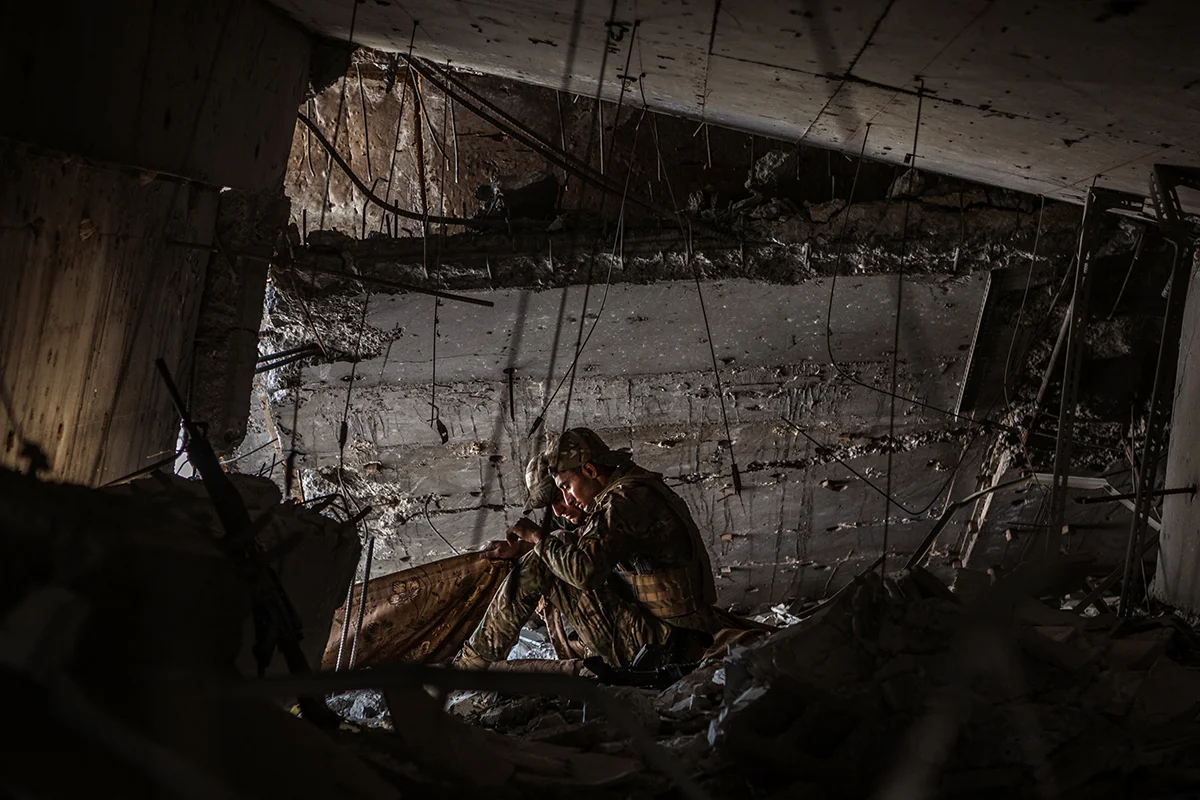 Two Iraqi soldiers string a sheet across a clearing to block the view of an ISIS sniper during an operation to reclaim the last remaining districts of western Mosul from the Islamic State. For two frustrating days, the Iraqi forces tried to push the frontline forward towards the last remaining medical complex under Islamic State control, only to be pinned down by sniper fire and forced to retreat. 