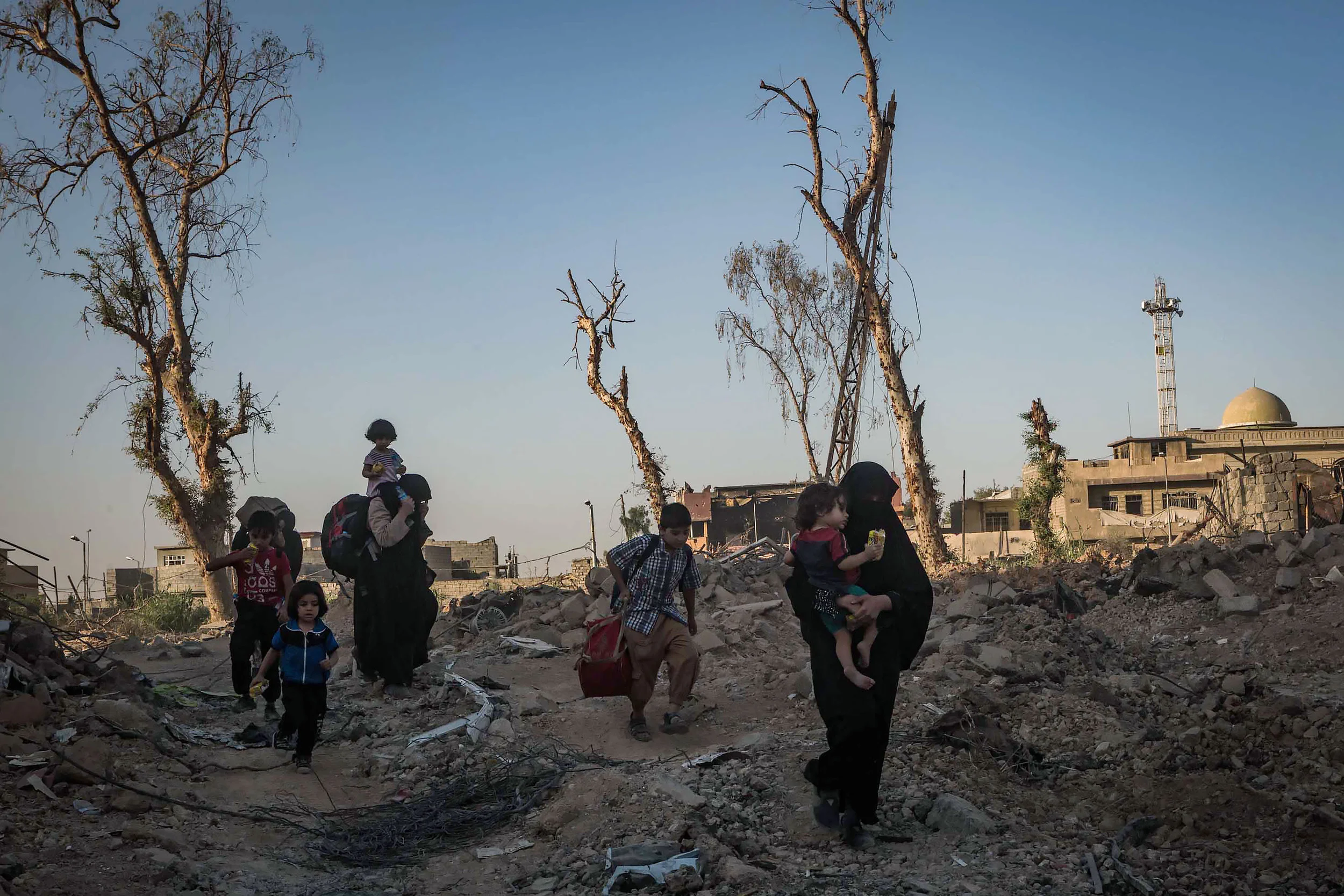 Civilians flee intense fighting between the Iraqi forces and the Islamic State in al-Zinjili neighborhood, one of the last remaining neighborhoods under Islamic State control.
