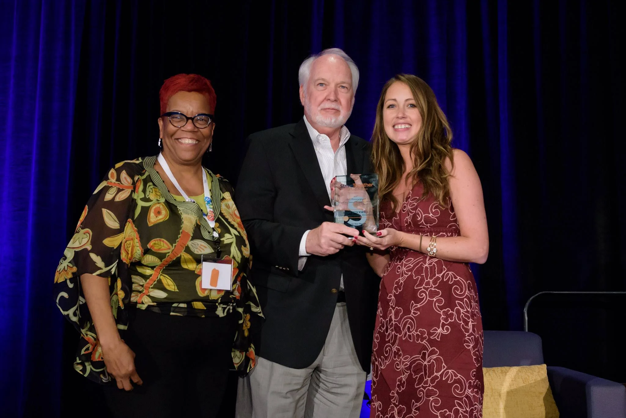 Danae Davis (l) from Milwaukee Succeeds Initiative and the Strive Together Board, celebrates the presentation of the Bill Henningsgaard Cradle to Career Champion Award to Dr. John Stockwell of the Spartanburg Academic Movement. The award was presented by StriveTogether network navigator Bridget Jancarz (r) in Phoenix, Arizona.
