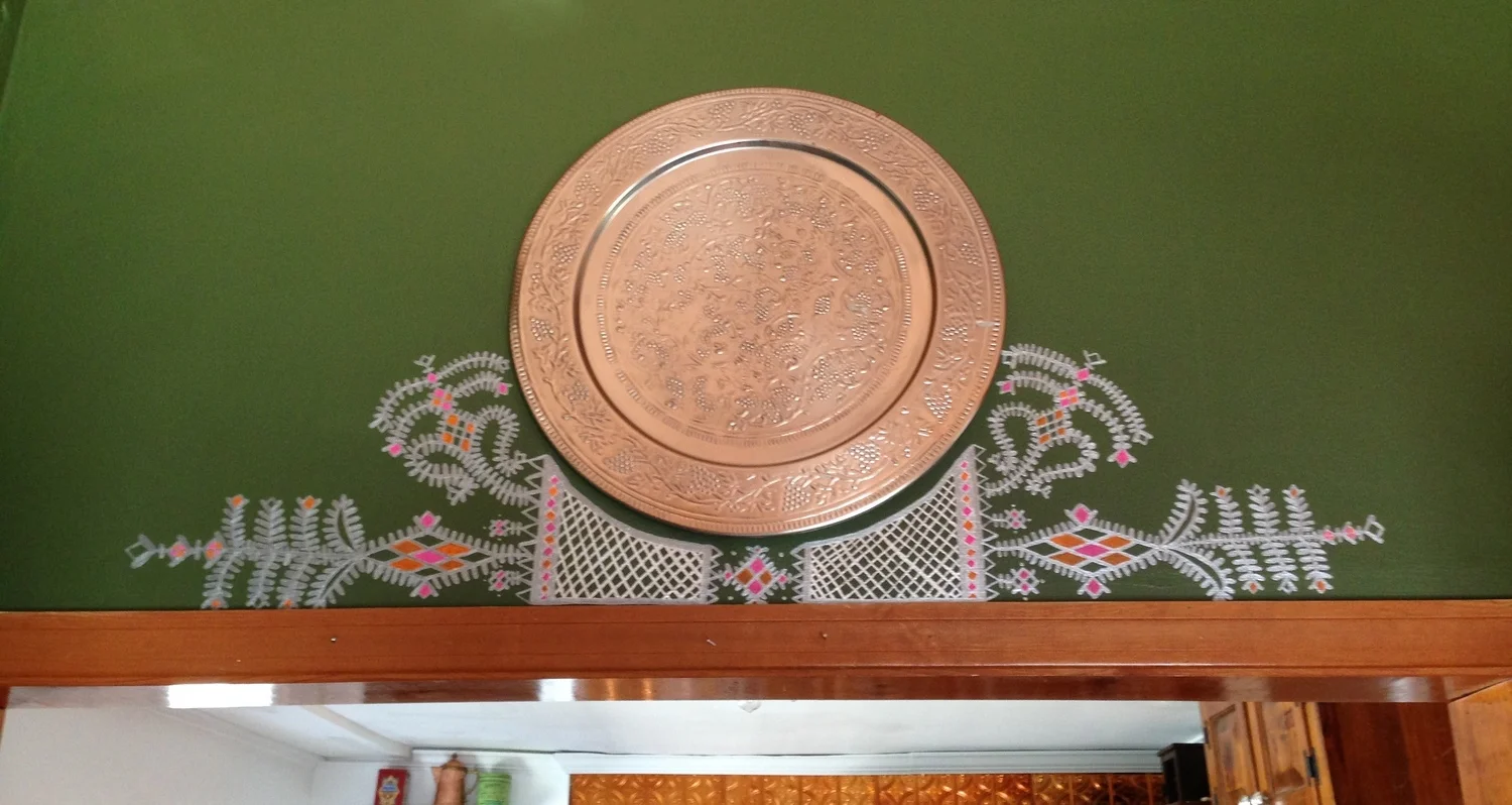Mural around platter above double-door frame