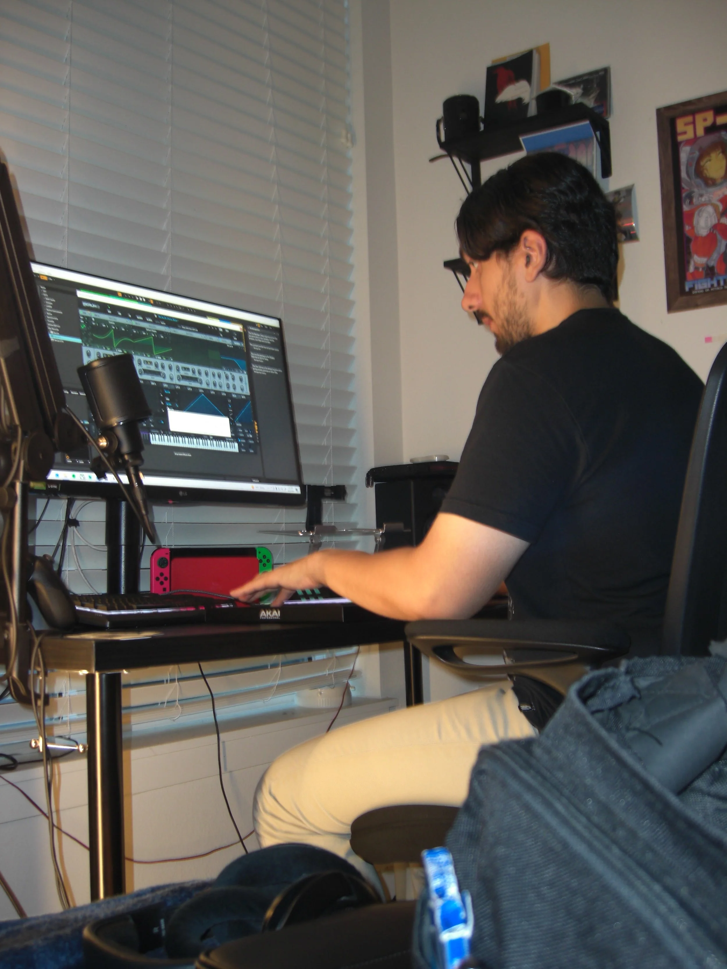 ElCrow recording vocals beside a studio microphone