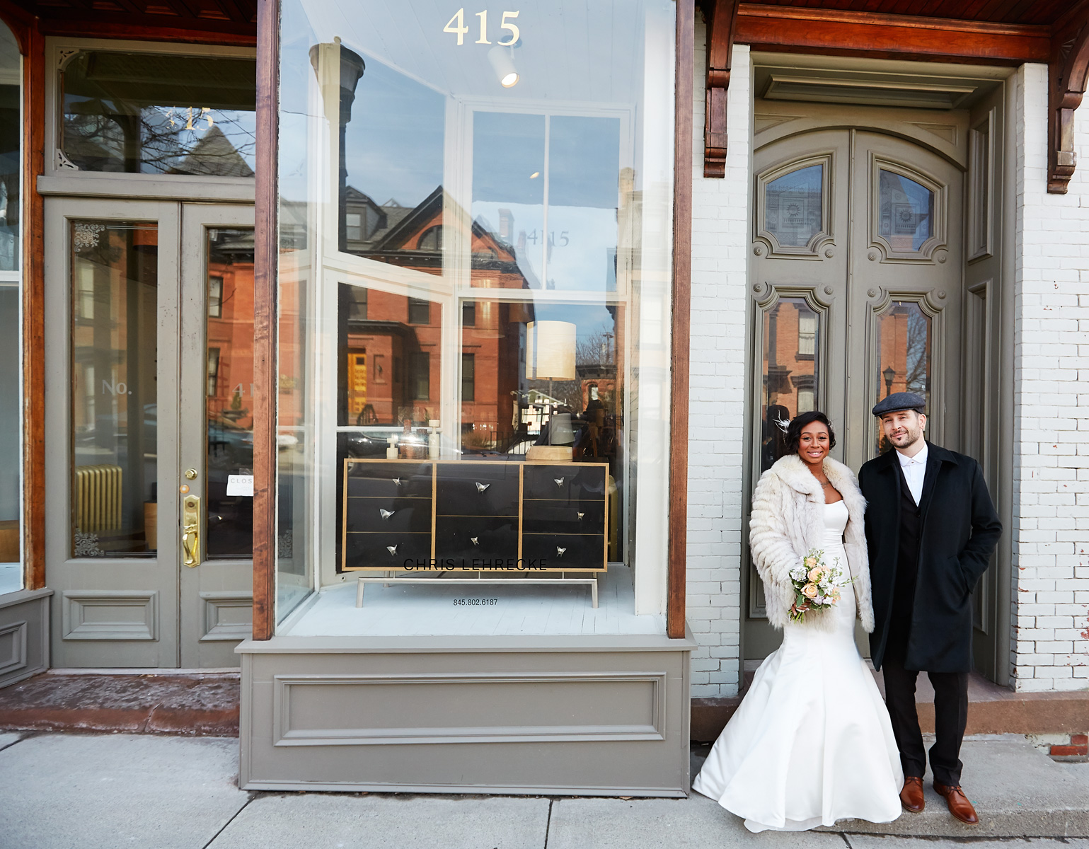 The newlyweds in the doorway of the Hudson Milliner.