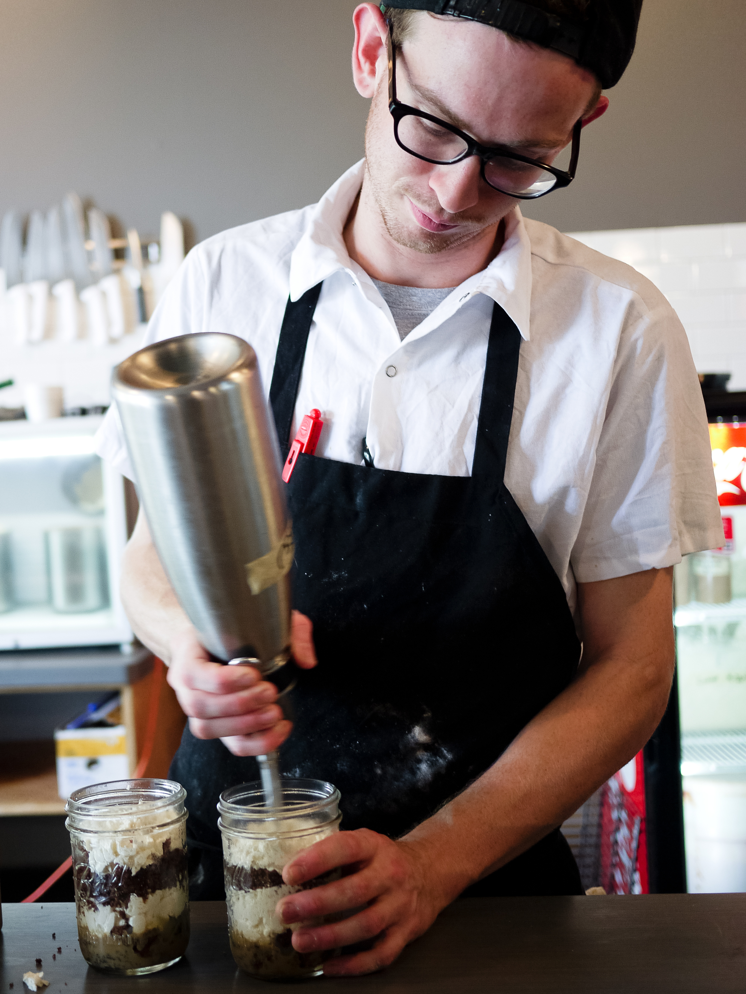 Brenden Eade fills jars with tiramisu.