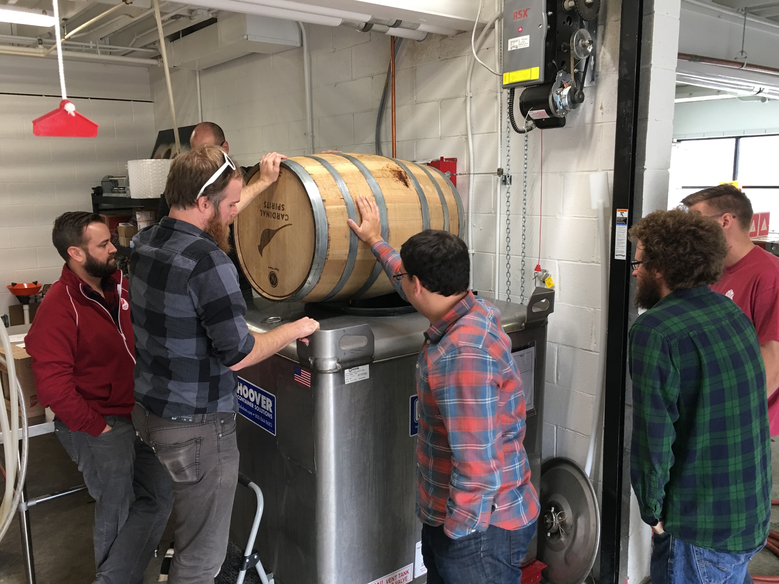 Emptying the whiskey barrel into the tank in preparation for bottling.