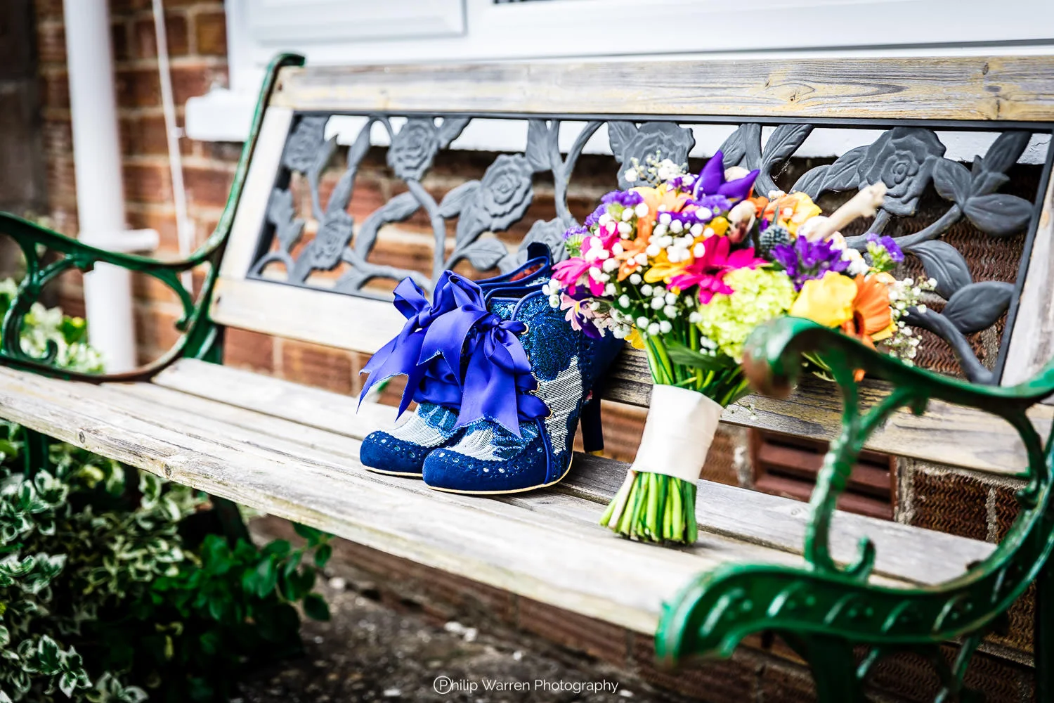 wedding shoes and bouquet of flowers on a bench