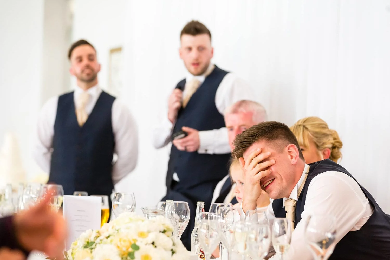 groom-listening-to-best-man-speech.jpg