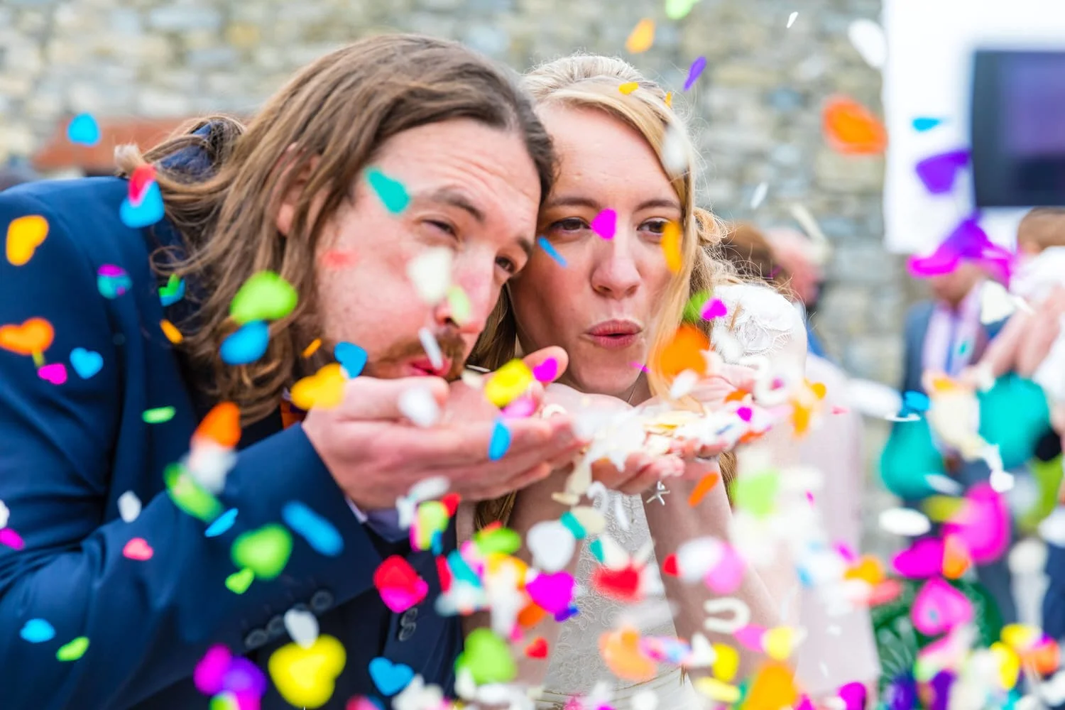 bride-and-groom-blowing-confetti.jpg