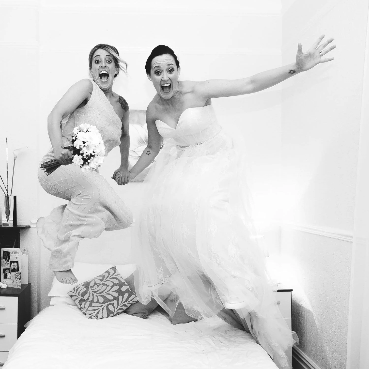 bride-and-bridesmaid-jumping-on-bed.jpg