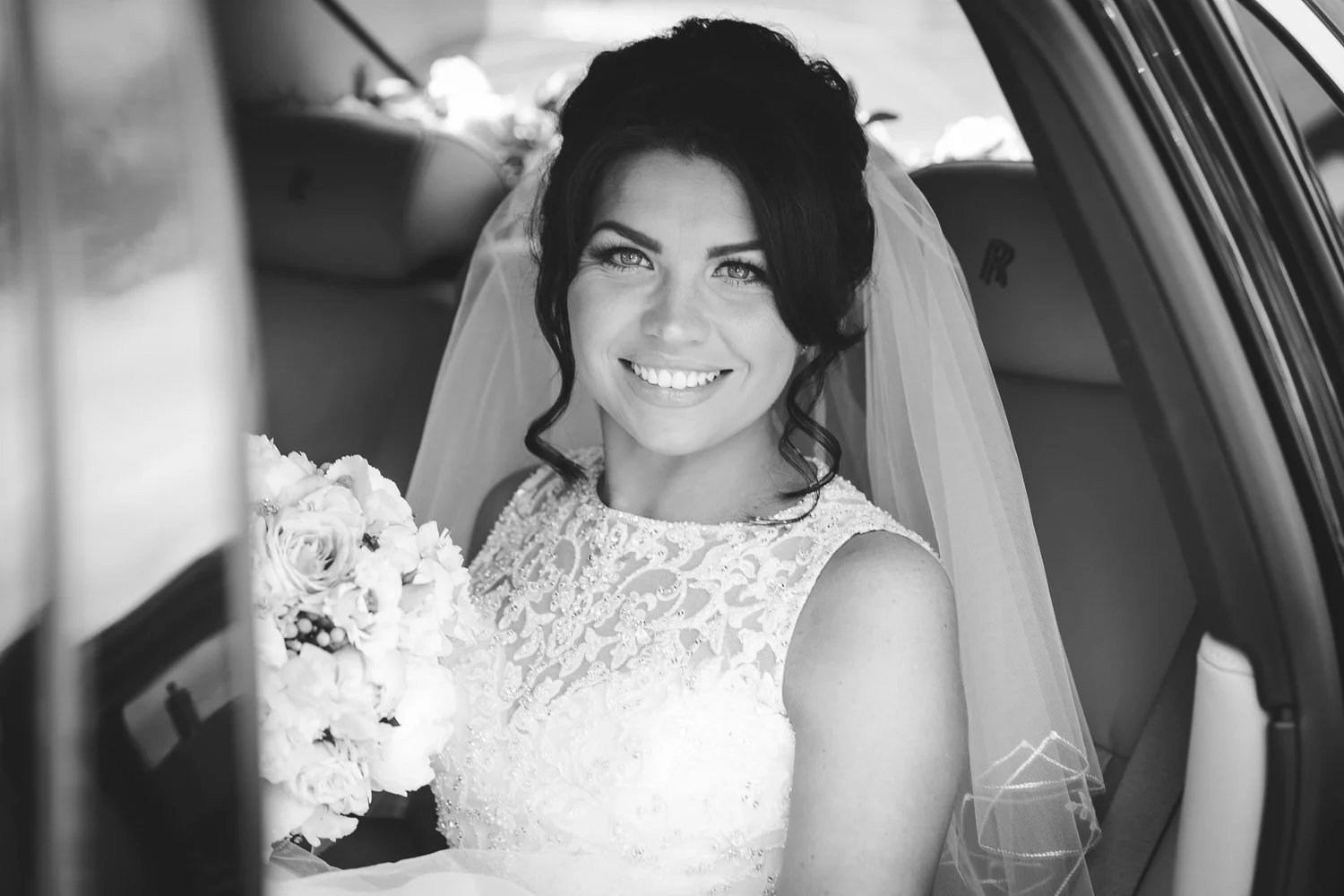 bride sat in wedding car