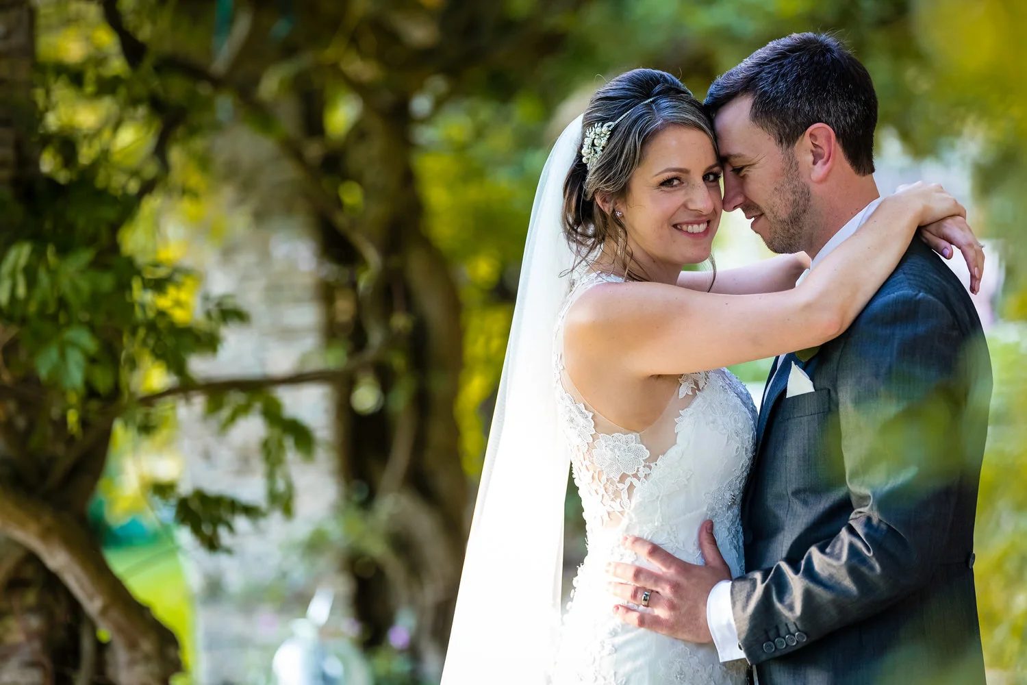 bride and groom embrace at glenfall house cheltenham