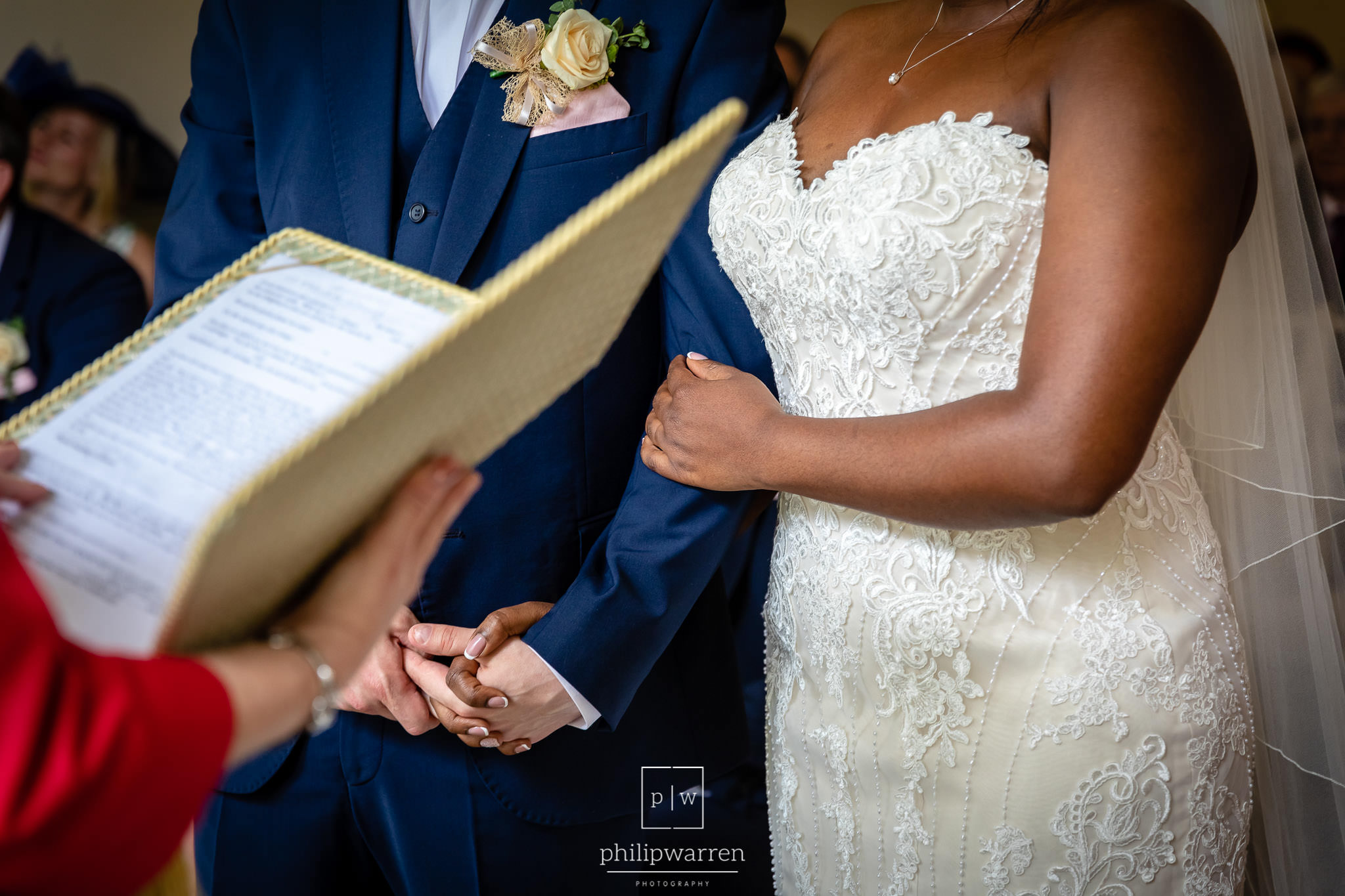bride and groom holding hands in wedding ceremony