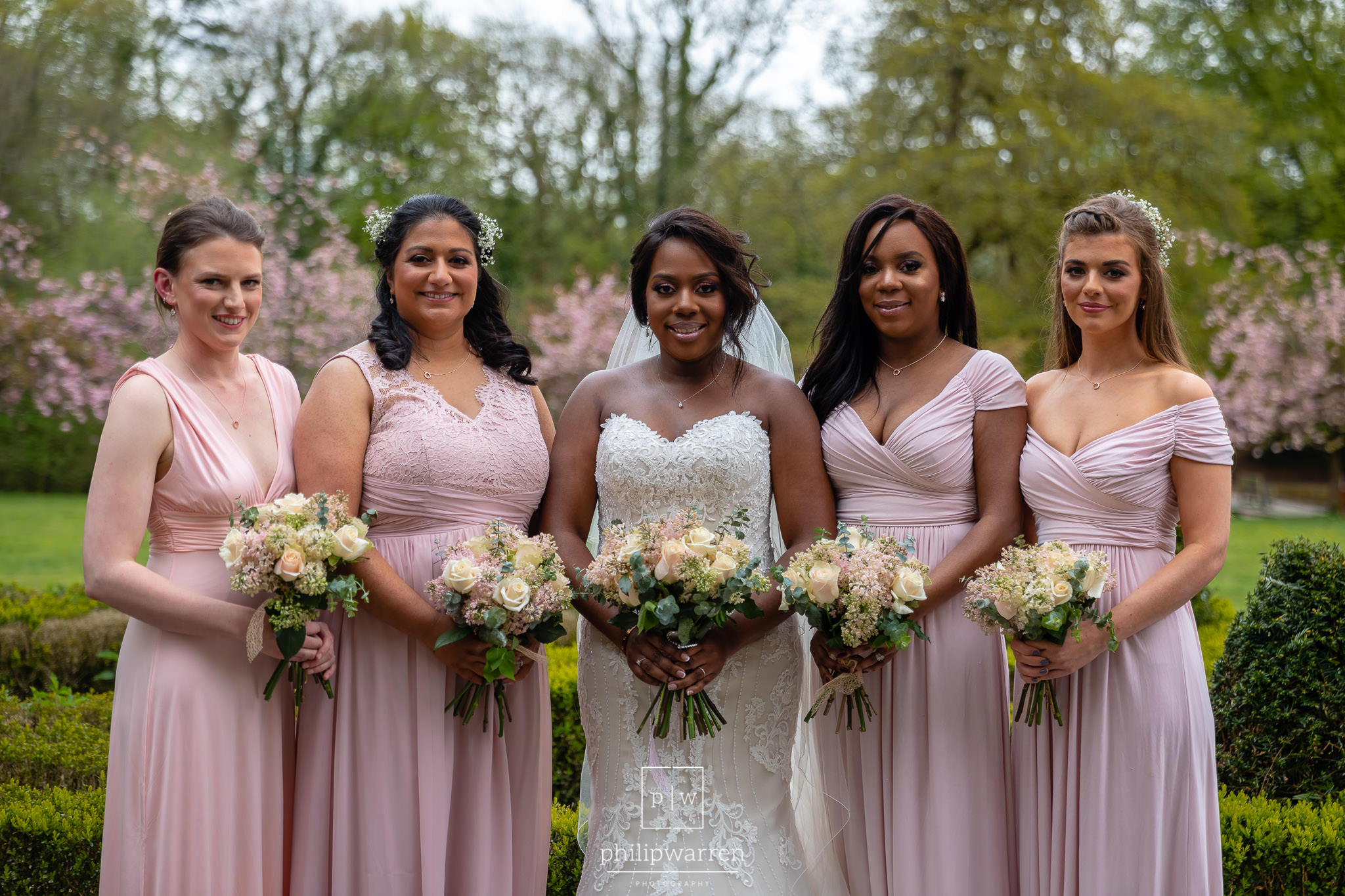 bride and four bridesmaids holidng their bouquets