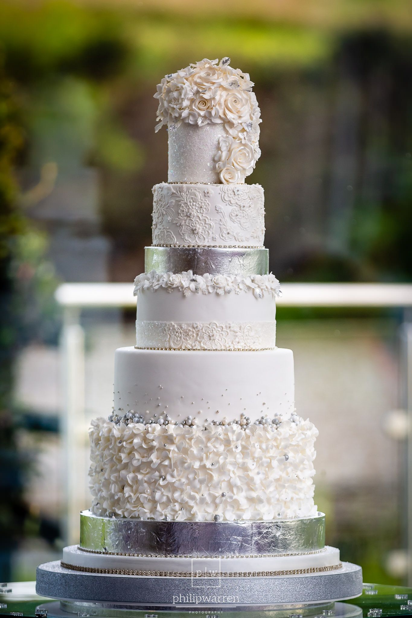 six tier white wedding cake on stand at oldwalls