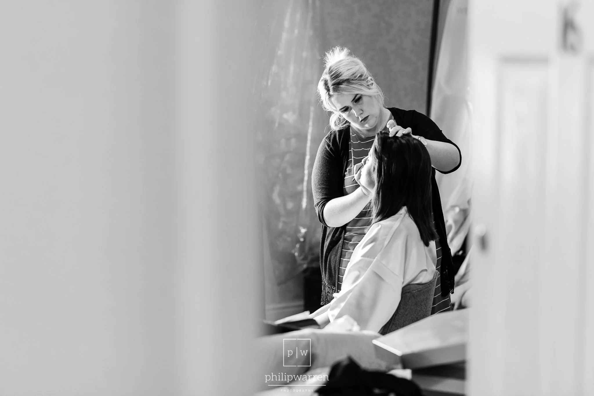 bride having makeup appled before wedding