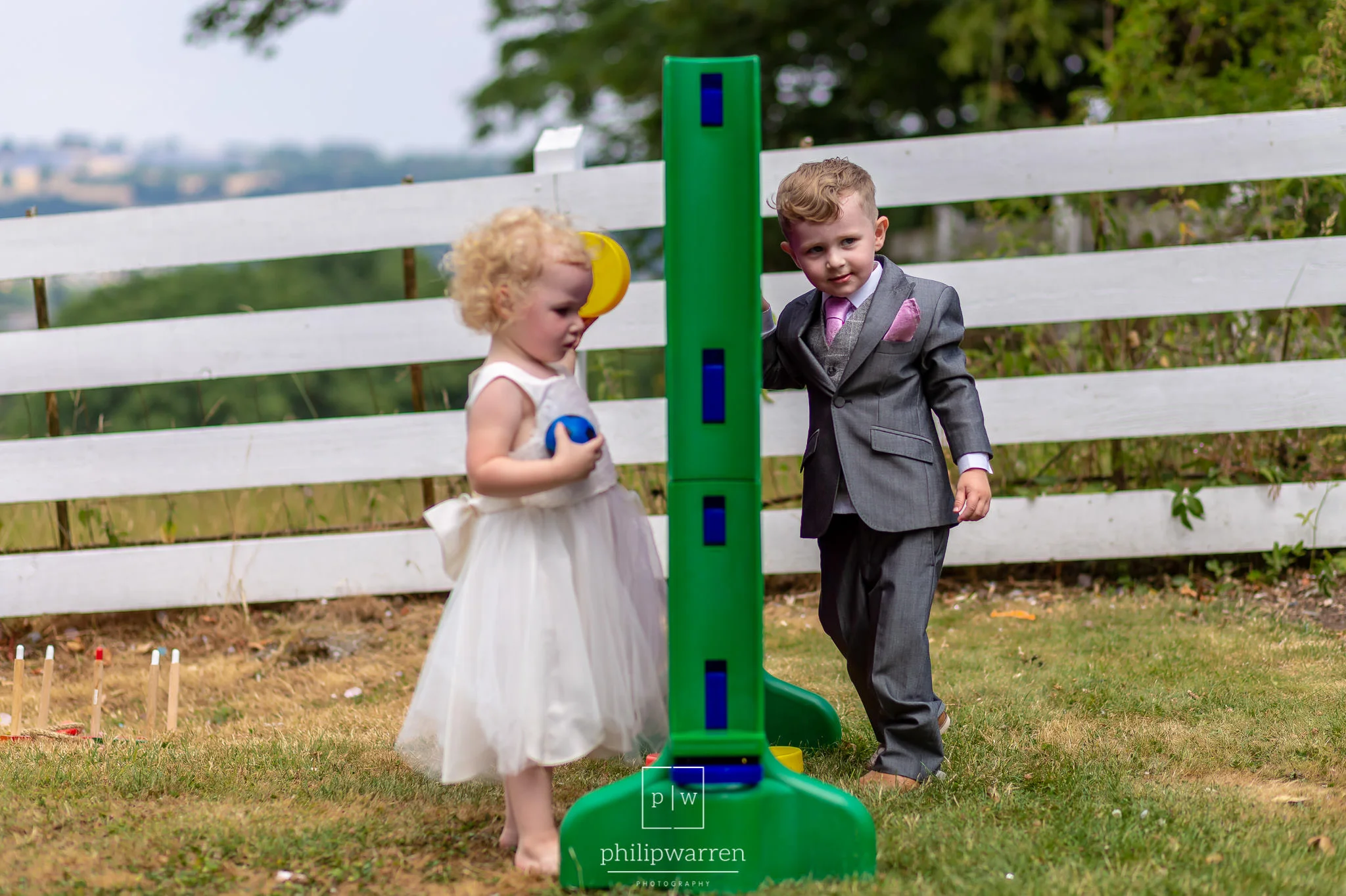 page boy and flower girl playing garden games