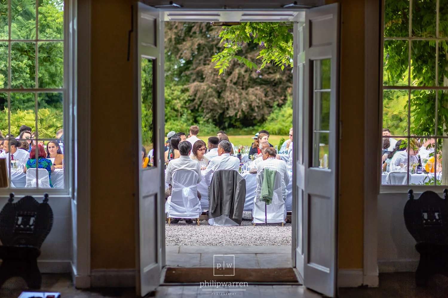 view of the outdoor wedding breakfast from inside plas glansevin