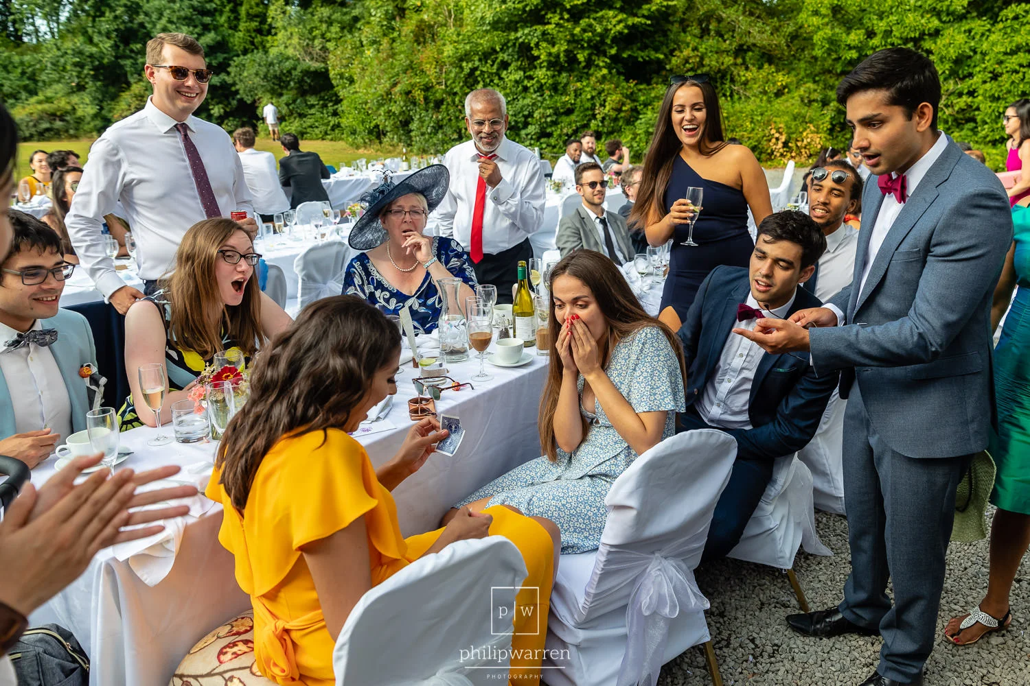 wedding guests at reception amazed by magician