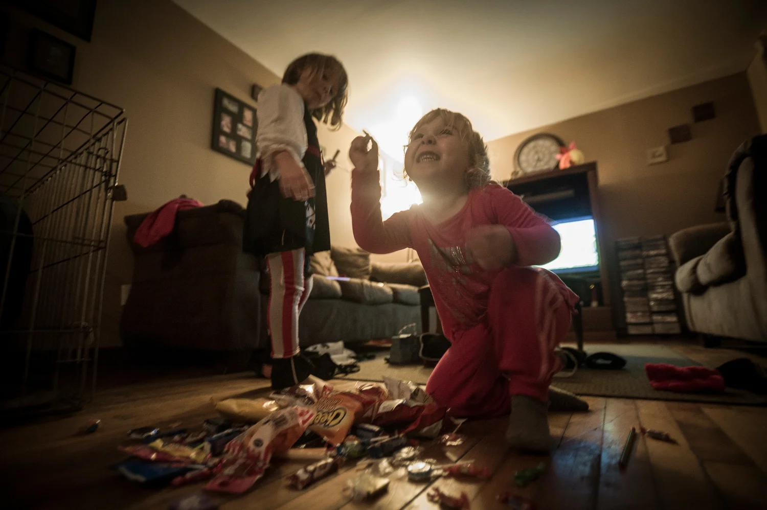 trick-or-treating Makenzie (L) shows off her candies from the night.