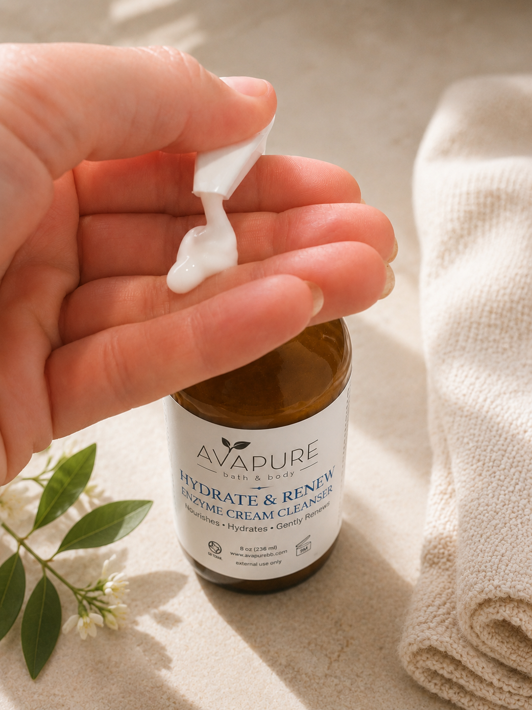 Hydrate + Renew Enzyme Cream Cleanser dispensing a rich, creamy cleanser that gently hydrates and exfoliates with fruit enzymes.