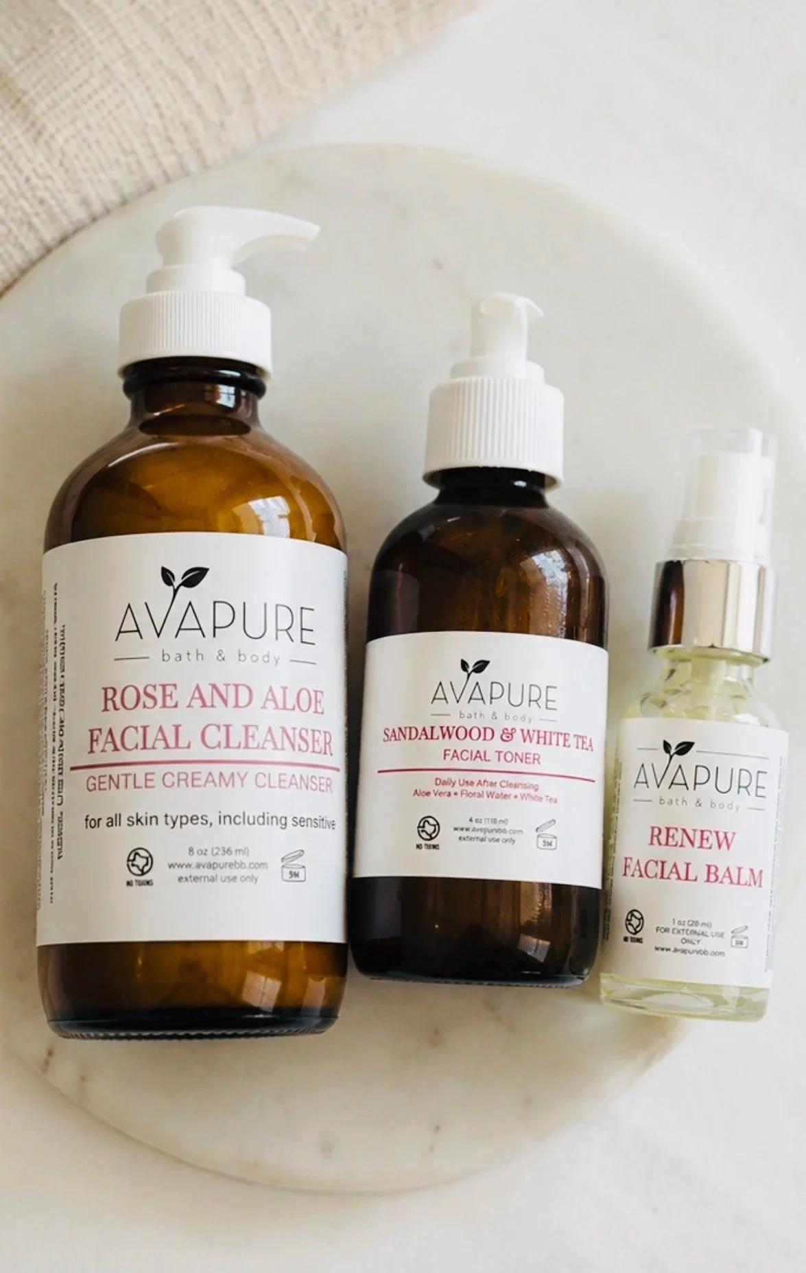 Gentle Creamy Cleanser, Facial toner and moisturizer bundled together for sensitive and reactive skin laid out on a marble plate.
