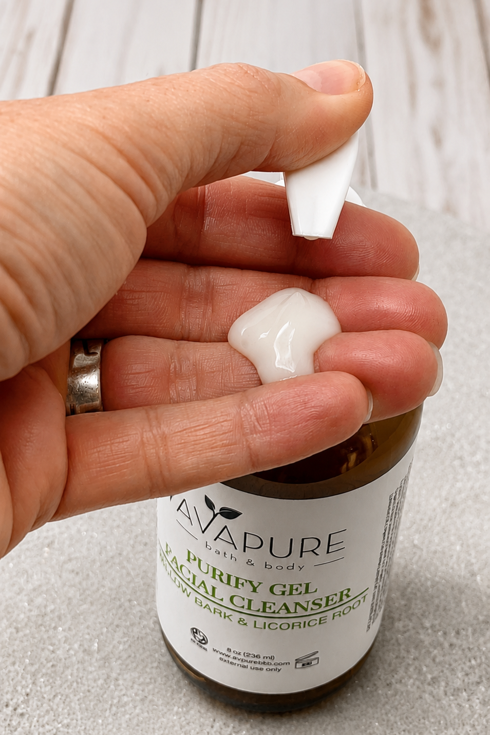 Purify Gel Cleanser dispensing a lightweight gel cleanser with gentle foaming formula for acne-prone and oily skin.