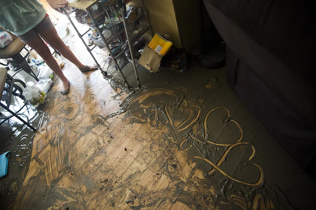 Jade Daffin, 10, draws hearts in the sludge left in her grandmother's destroyed home on Plantation Island on Wednesday, September 13, 2017 in Everglades City, three days after Hurricane Irma. Nancy Daffin returned to her home three days after the storm to find it in ruins.