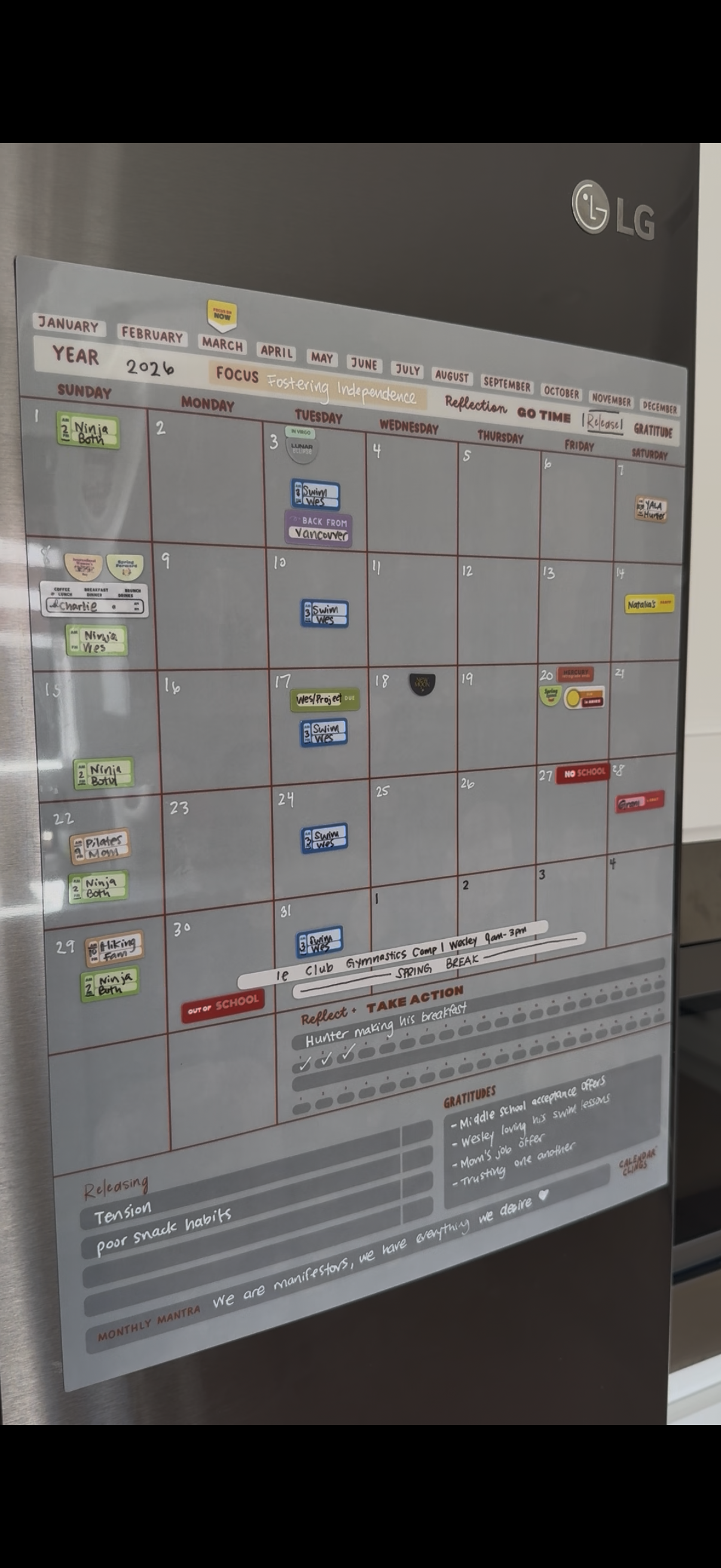 reusable dry erase calendar with colorful calendar clings for family scheduling