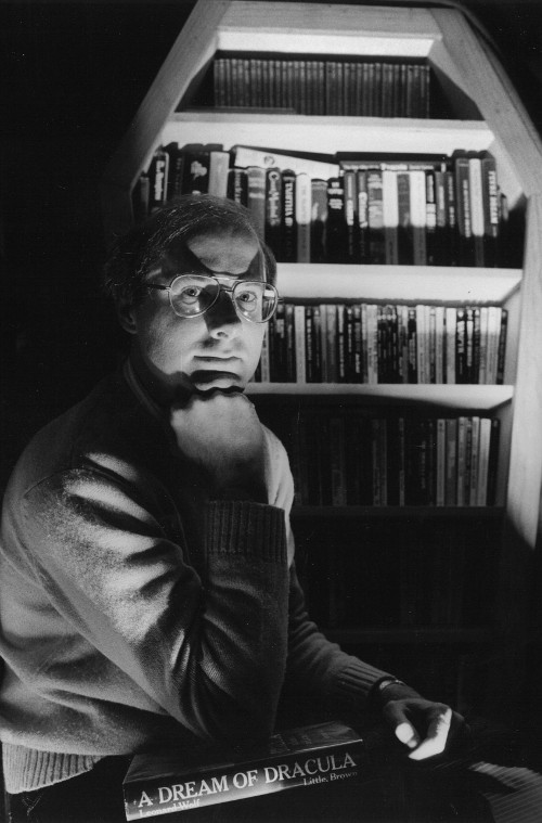 Author's photo for The Vampire in Verse: An Anthology . The custom-made coffin-shaped bookshelf housed Moore ' s vampire library, 1984. (Photo by Rhoda Pollack)