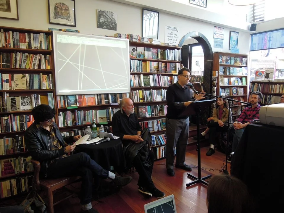 Peter Maravelis (right) introduces László Krasznahorkai (center) and Mauro Javier Cardenas (left) at City Lights Books on June 27, 2013.