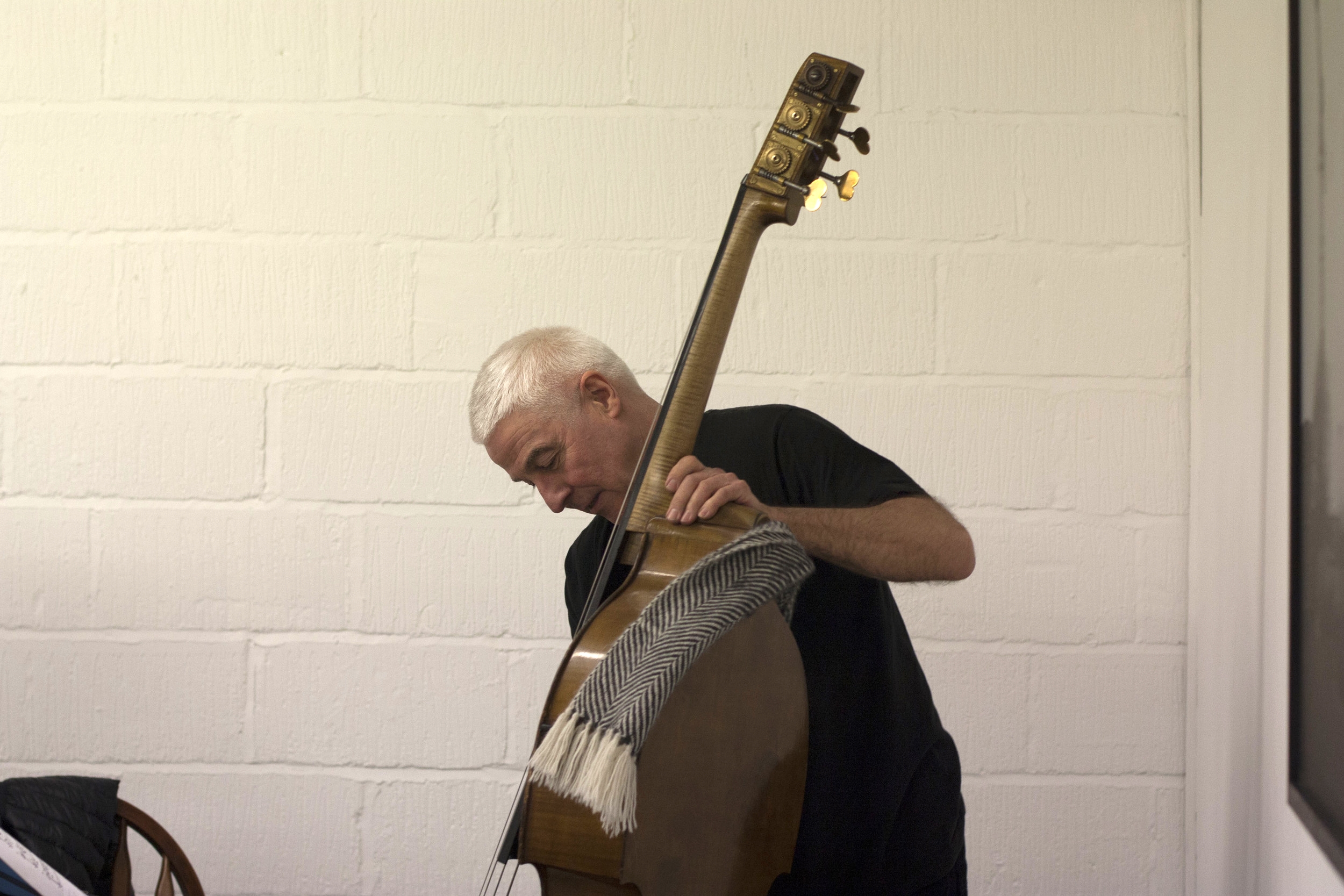  Barry Guy warms up for the evening's first set. 