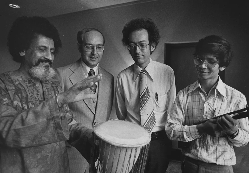 Halim El-Dabh demonstrates a drumming technique for ethnomusicologists William Anderson (second from left) & Terry E. Miller, & Thai graduate student Kovit Kantasiri (courtesy Kent State University Libraries, Special Collections and Archives)