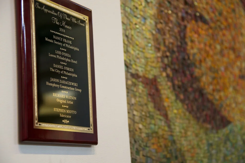 A plaque acknowledging the work of those who led the effort to save the mosaic now graces the column to the left of the work.