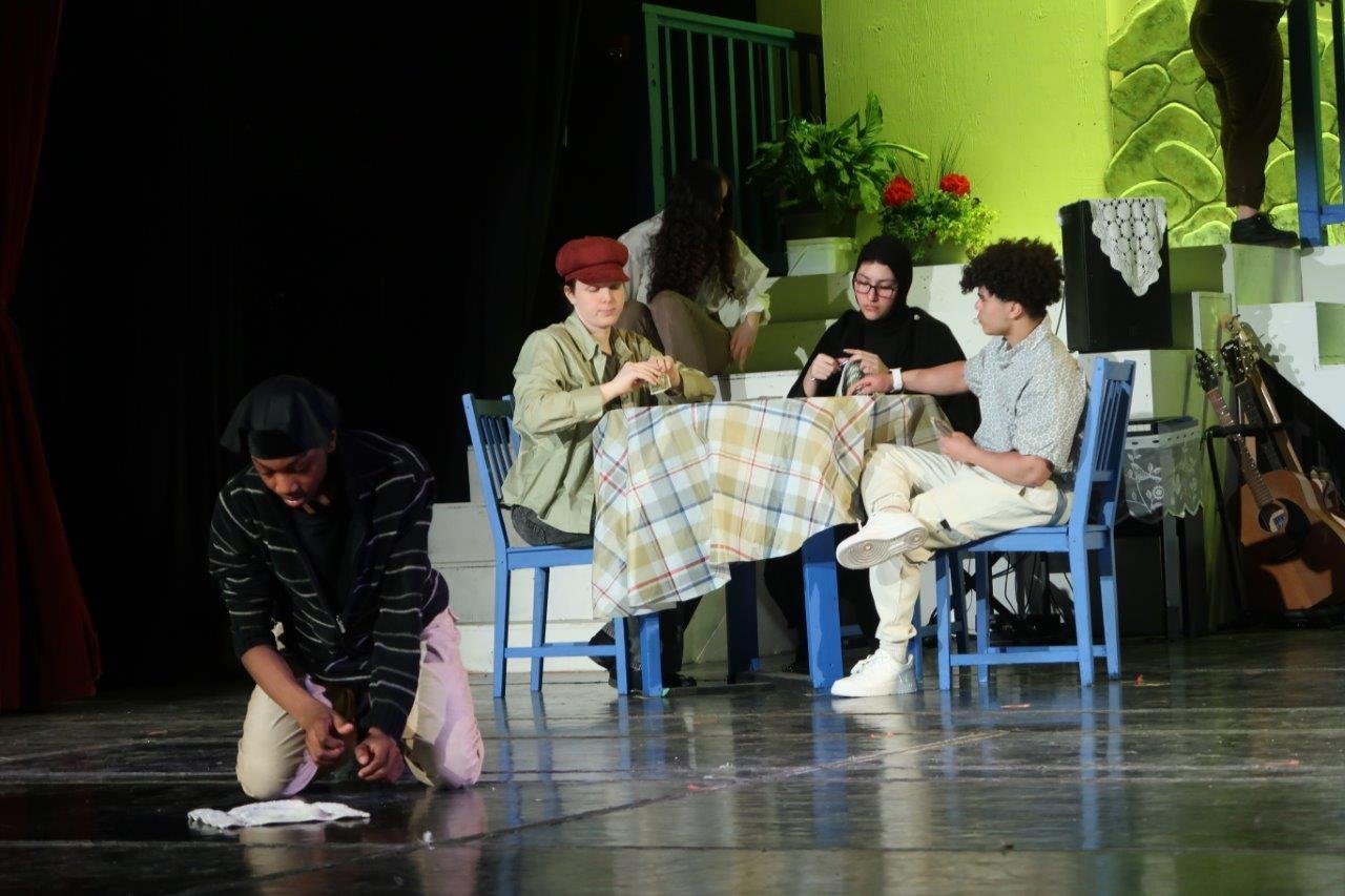  Taverna scene with people at table and one worker wiping the floor 