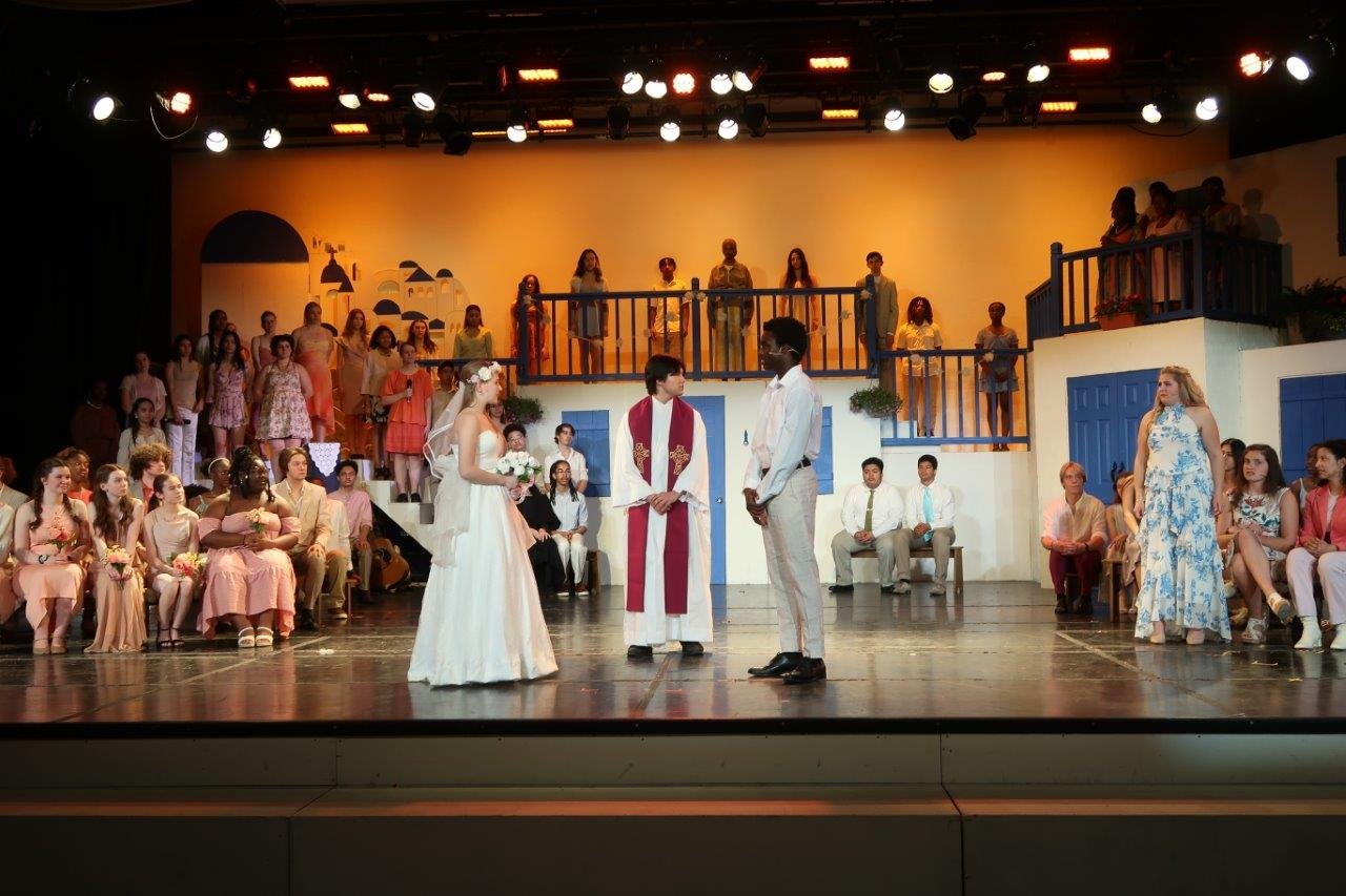  Church scene with Sophie, the priest, and Sky in the centre as Donna stands up to speak up. 