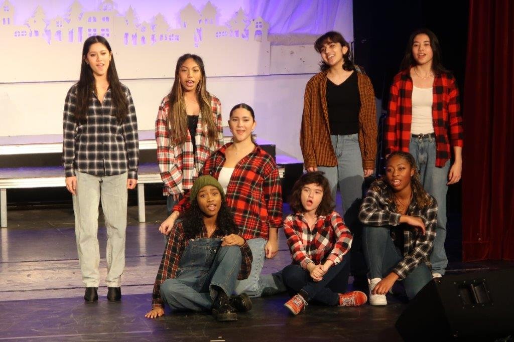  Group of singers wearing plaid sweaters 