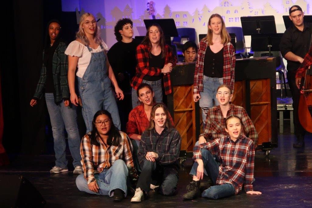  Group of singers wearing plaid sweaters 