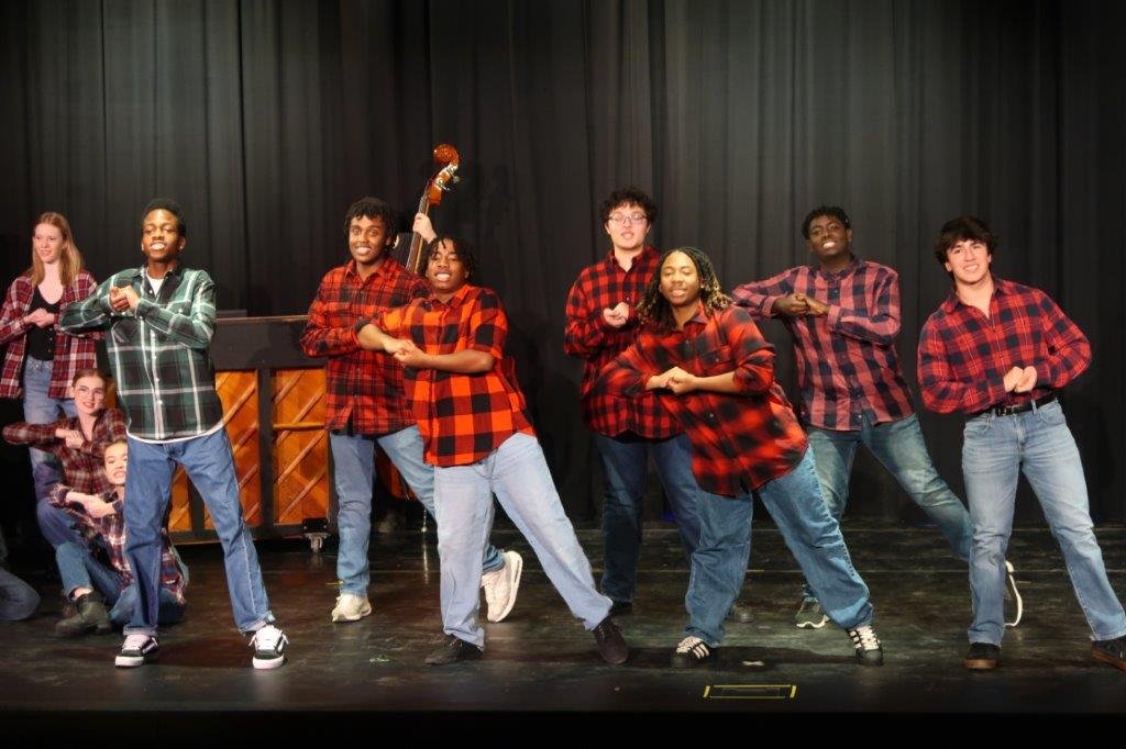  Group of singers wearing plaid sweaters 